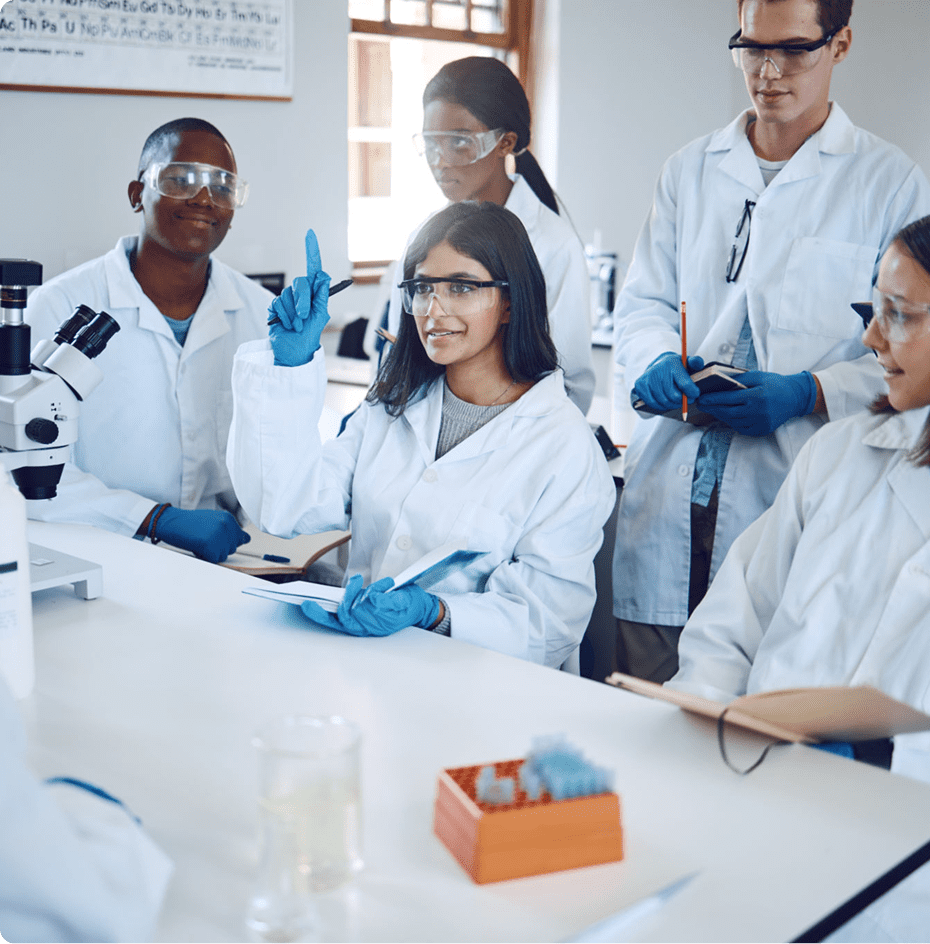 Scientists collaborating in a laboratory, wearing white coats and blue gloves.